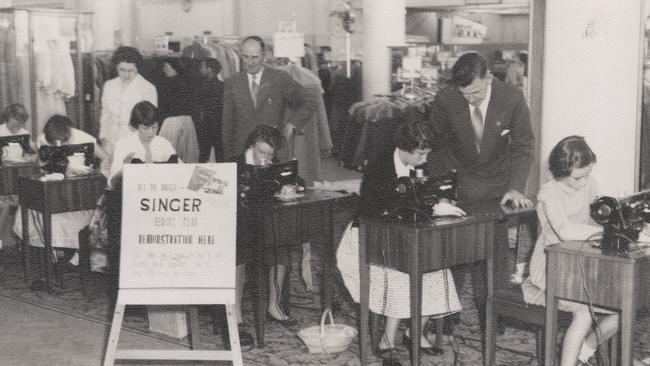 Women and girls use sewing machines at the Singer Sewing Club in Moore's department store in Adelaide, 1957. State Library of SA / PRG1644/2/7