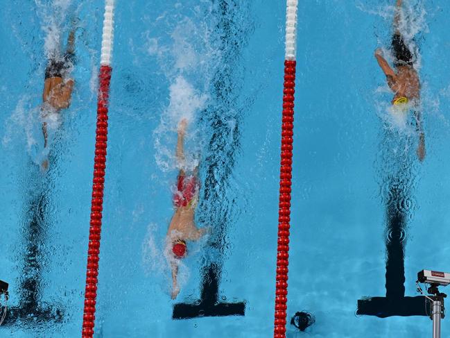 An overview shows China’s Pan Zhanle (C) as he wins the 100m freestyle at the Paris 2024 Olympics, in world record time and by a vast margin over Australia’s Kyle Chalmers (R). Picture: AFP