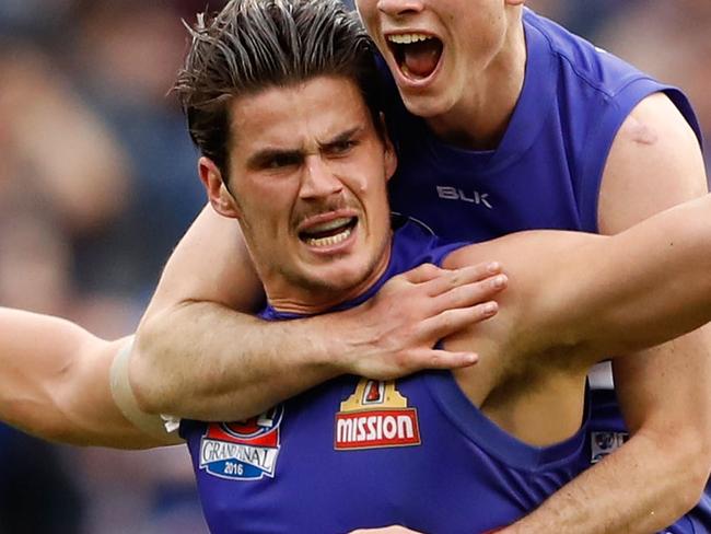 MELBOURNE, AUSTRALIA - OCTOBER 01: Tom Boyd of the Bulldogs celebrates a goal with Toby McLean of the Bulldogs during the 2016 Toyota AFL Grand Final match between the Sydney Swans and the Western Bulldogs at the Melbourne Cricket Ground on October 01, 2016 in Melbourne, Australia. (Photo by Adam Trafford/AFL Media/Getty Images)