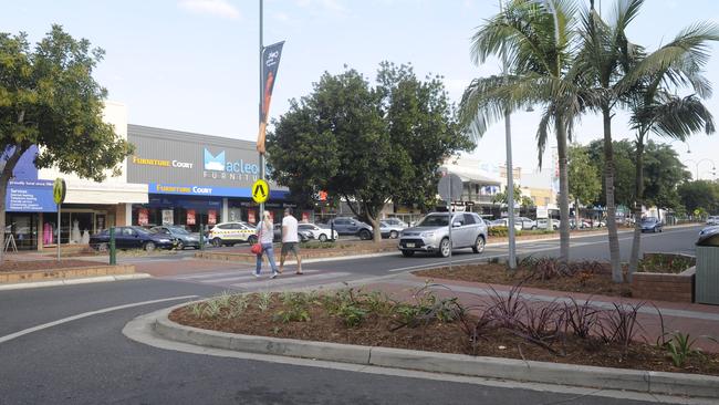 CROSSING: Two pedestrians cross the road in Grafton's CBD. Gardens in the centre strip have been blamed to reduce pedestrian visibility.