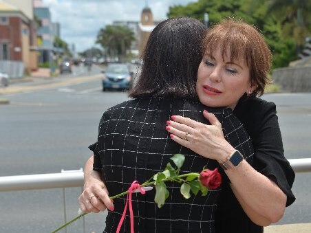 Broken Ballerina Foundation director Jules Thompson with a fellow victim of domestic violence at the Red Rose Rally in Mackay this year.