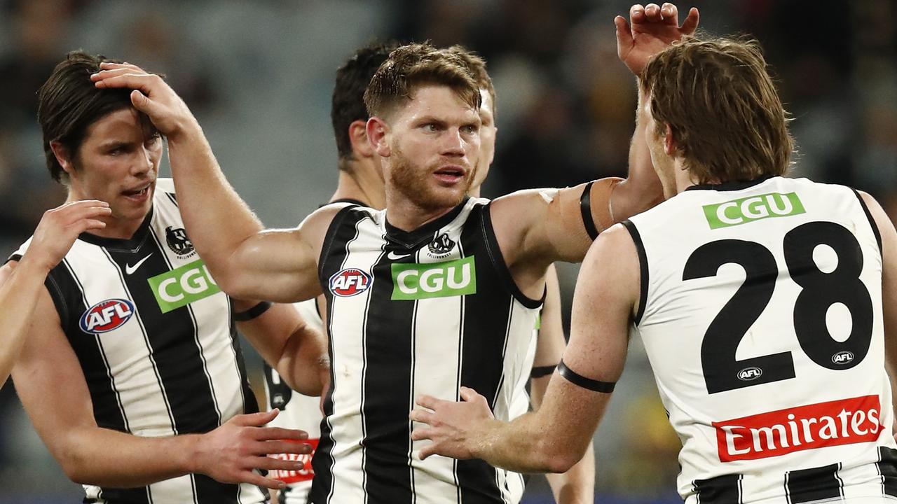 Taylor Adams congratulates teammates during Collingwood’s clash with Richmond at the MCG in July 2021.