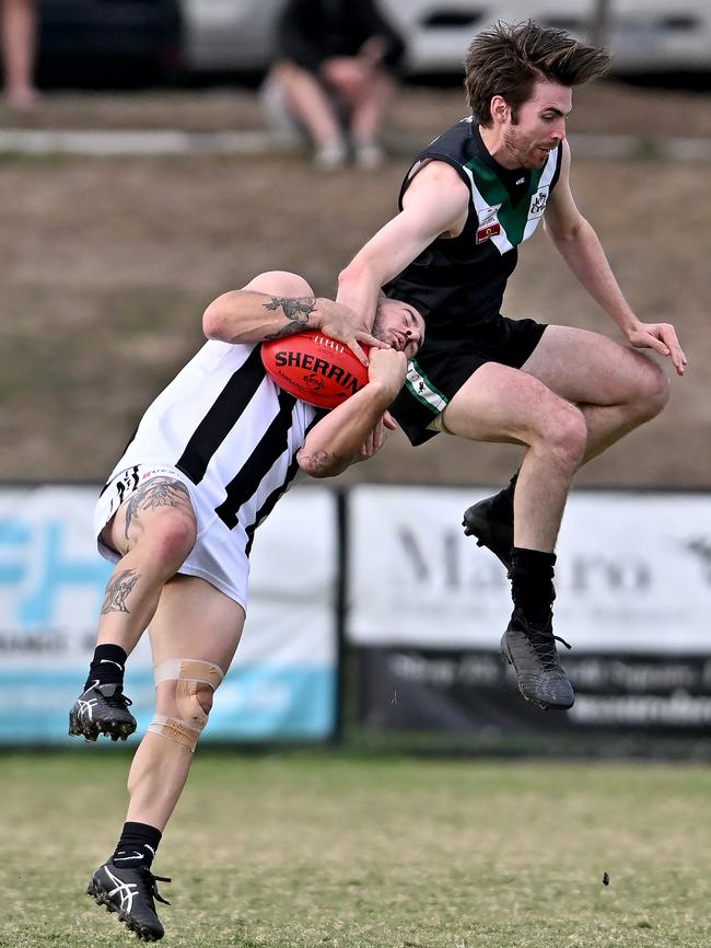 Eastern: Scoresby’s Todd Morgan cops it from Donvale’s Luke Manion. Picture: Andy Brownbill