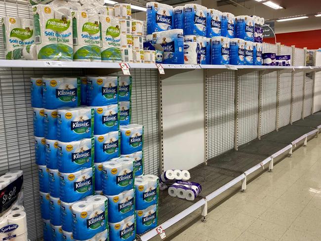 Near-empty shelves of toilet paper are seen at a supermarket in a Melbourne on June 26, 2020. - Supermarkets imposed purchase limits on toilet paper across Australia on June 26 following panic buying by people rattled over a surge in coronavirus cases in the country's second-biggest city. (Photo by William WEST / AFP)