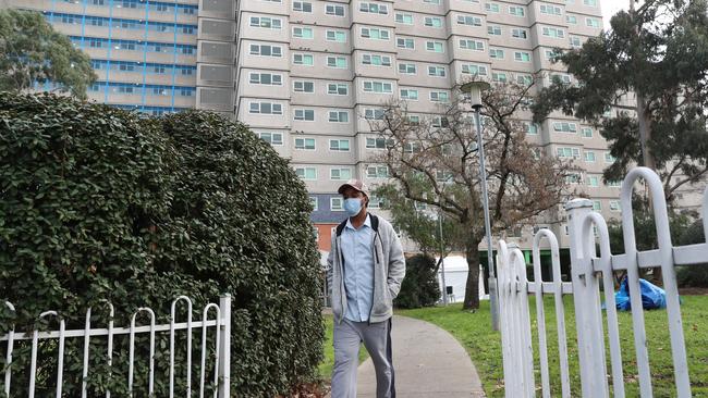 A man goes for a walk after leaving one of the towers in North Melbourne. Most of the public housing towers which have been in a strict lockdown have now been put on standard lockdown. Picture: NCA NewsWire / David Crosling