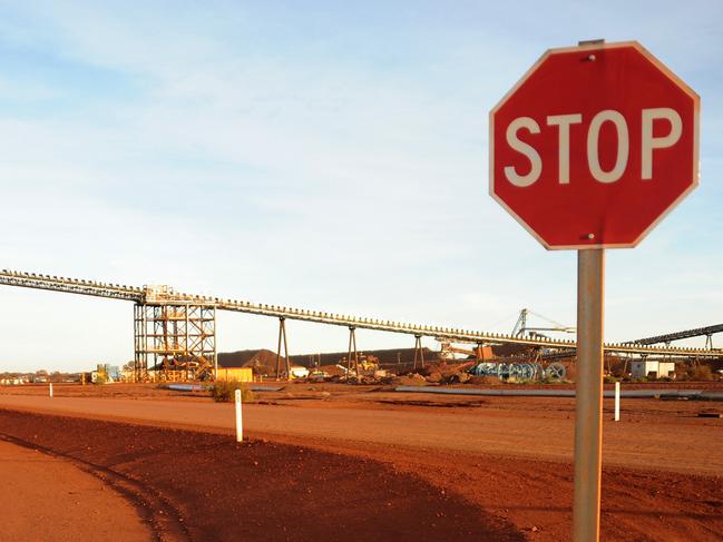 A stop sign stands at the entrance to the crushing facility at Fortescue Metals Group, Cloudbreak Iron Ore operation in Cloudbreak in Western Australia, on Monday, Jul. 25, 2011. Photographer: Carla Gottgens/Bloomberg