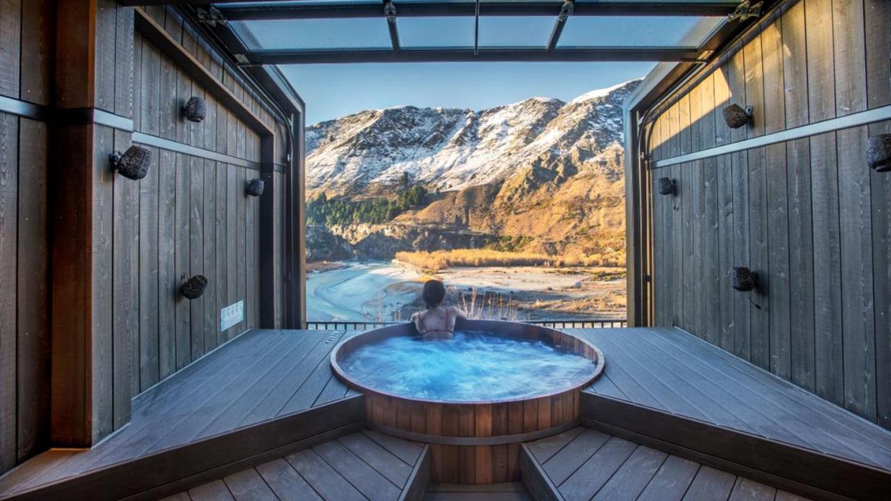 Enjoy the most relaxing hour of your life in the Queenstown Onsen Hot Pools with their breathtaking view of Shotover River. Image: Klook.