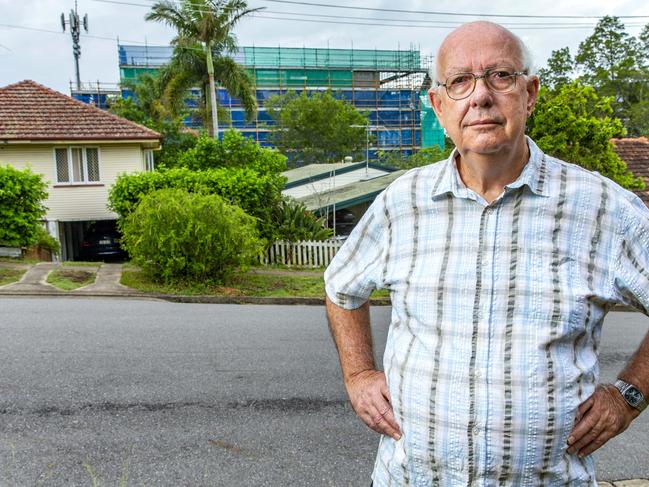 Indooroopilly resident Michael Yates poses for a photograph at the site of a proposed development in Rylatt Street, Sunday, January 12, 2020 (AAP Image/Richard Walker)