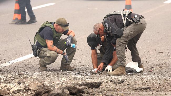 Israeli soldiers inspect the impact site of a reported rocket fired from Lebanon in central Israel on Tuesday. Picture: AFP