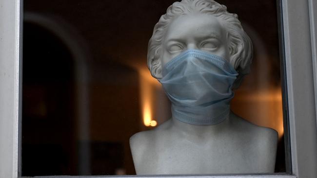 A bust of the former composer Ludwig van Beethoven is decorated with a protective mask in a store window in Weimar, Germany. Picture: AFP