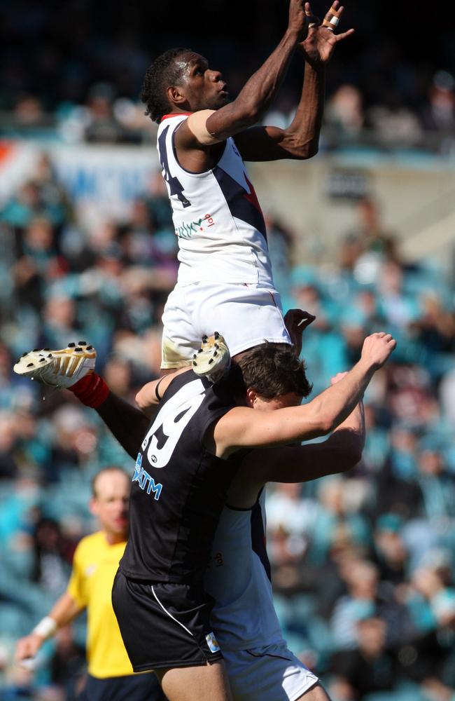 Footballer Liam Jurrah flies over Port Adelaide’s Nick Salter in Adelaide to take the 2010 AFL mark of the year.