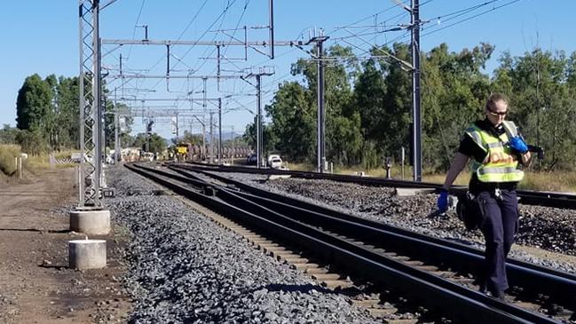 An officer walks along the line following the smash.