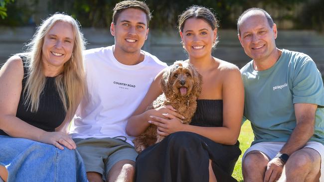 Thursday MARCH 07 2024 South Adelaide footballer Zac Dumesny with his mum Nicole, dad Duane and girlfriend Sammi with dog Darcy. Story following his successful return to playing after brain surgery. Picture: RoyVphotography