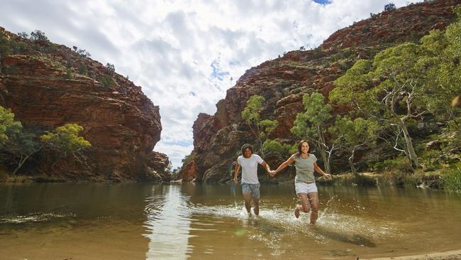 <source>Tourists at Ellery Creek Big Hole in Tjoritja/ West MacDonnell National Park, 161km west of Alice Springs. NT tourism industry figures say it is time for Territorians to step up and use their $200 vouchers. <s1/><source>Picture: Tourism Central Australia </source></source>