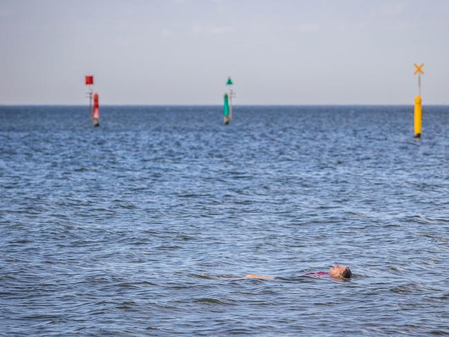 A swimmer in St Kilda as the mercury soars on Friday morning. Picture: Jake Nowakowski