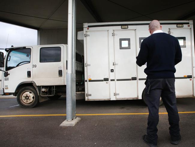 A prison guard waits outside the admissions area. Picture: David Caird