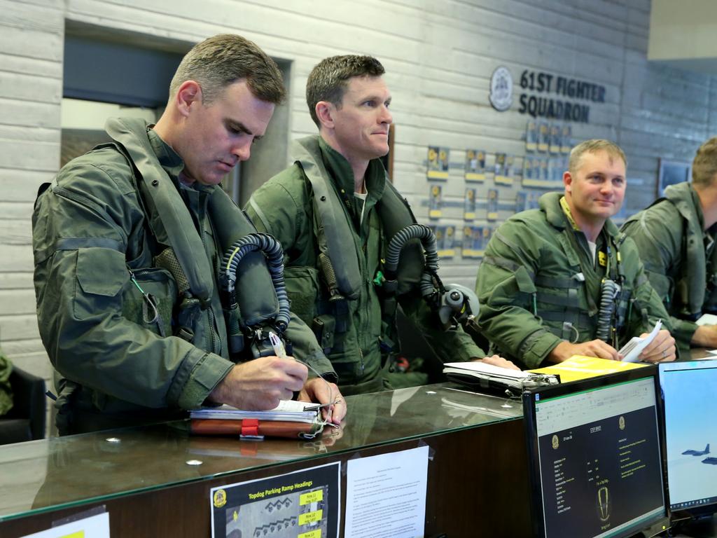 Australian Pilots training in the F35 fighter Jets Luke Airforce Base in Phoenix Arizona. (LtR) Squadron Leader Wing Commander Darren Clare, Squadron Leader “Jacko”, Lieutenant colonel Rhett Hierlmeier (US Air Force) prepare for a flight. Picture: Nathan Edwards