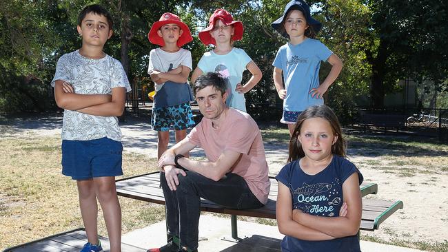 The students and parent Sam Hopgood at Ottery Reserve, which neighbours Merri Creek Primary. Picture: Ian Currie