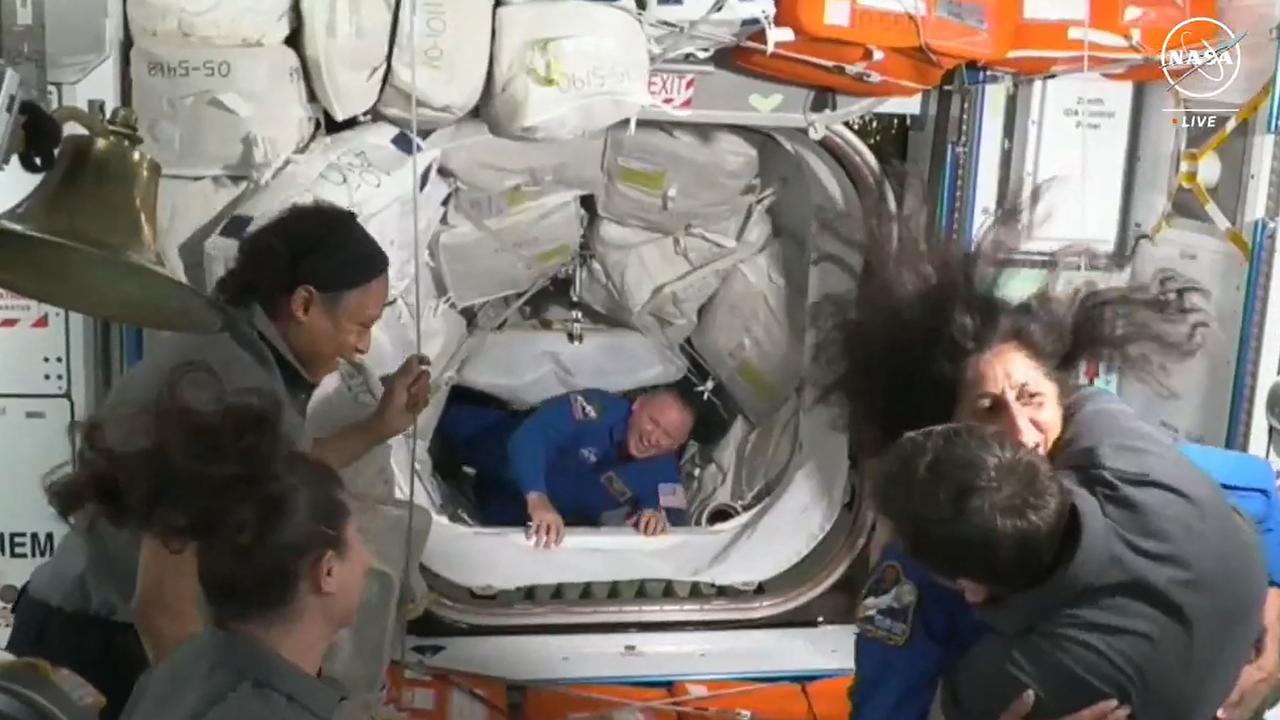 Suni Williams, right, and Butch Wilmore, centre, were greeted by resident ISS astronauts after boarding on June 6. Picture: AFP Photo/NASA