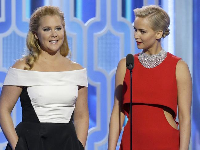 Amy Schumer and Jennifer Lawrence appear together onstage during the 73rd Annual Golden Globe Awards.