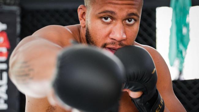 (FILES) In this file photo taken on September 14, 2021, French MMA heavyweight athlete Ciryl Gane poses in a gymnasium, in Paris. – Gane is set to fight against MMA legend Jon Jones in an attempt to get the UFC heavyweight belt. (Photo by GEOFFROY VAN DER HASSELT / AFP)