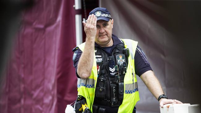 A police officer at the border blockade gestures to traffic. Picture: Nigel Hallett