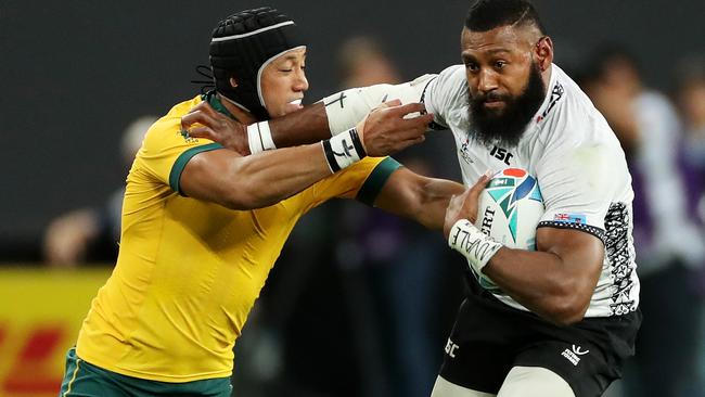 SAPPORO, JAPAN - SEPTEMBER 21: Waisea Nayacalevu of Fiji fends off Christian Lealiifano of Australia to score his side's second try during the Rugby World Cup 2019 Group D game between Australia and Fiji at Sapporo Dome on September 21, 2019 in Sapporo, Hokkaido, Japan. (Photo by David Rogers/Getty Images)