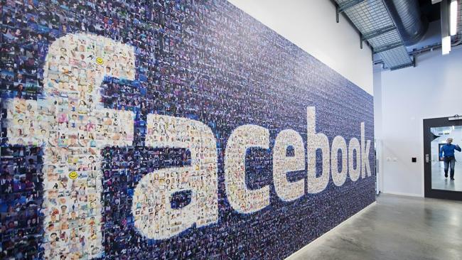 A big logo created from pictures of Facebook users worldwide is pictured in the company's Data Center, its first outside the ...