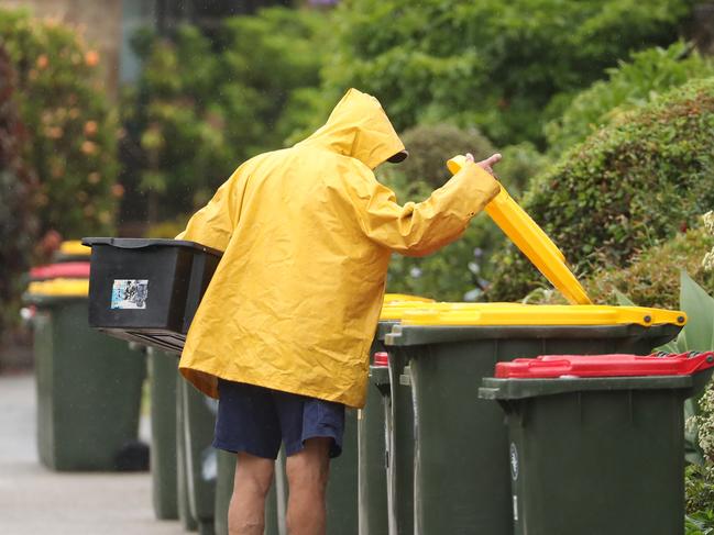 Red and yellow topped bins on the verge – have you ever put excess rubbish in your neighbours bin? Picture: John Grainger