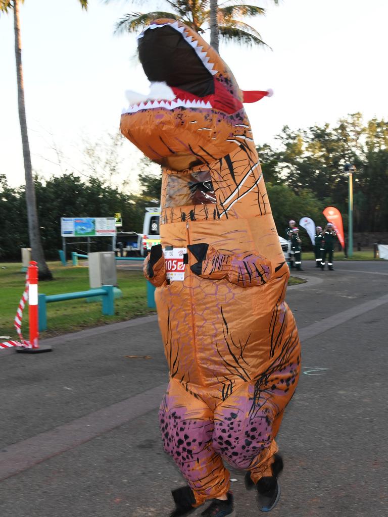 Chris Chase dressed up as a dinosaur at the Darwin Santa Fun Run in July at Mindil Beach. Picture Katrina Bridgeford