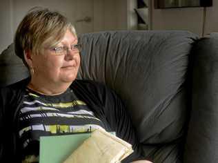 Janene Cleaver with her original adoption papers and the photo album she made for her mum.