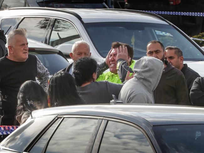 Distressed relatives at the scene. Picture: David Caird