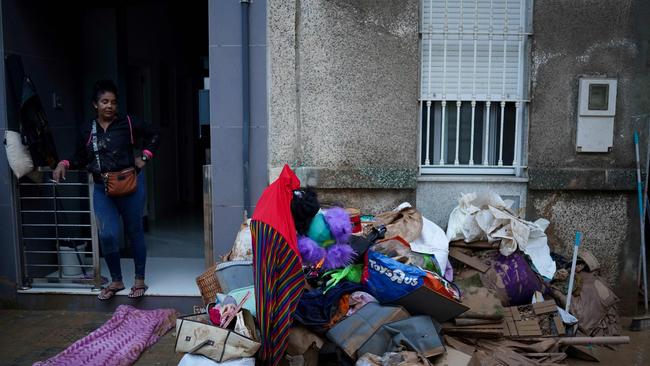 A resident stands next to bags on the pavement following deadly floods in Alfafar neighbourhood, south of Valencia. Picture: Manuare Quintero/AFP