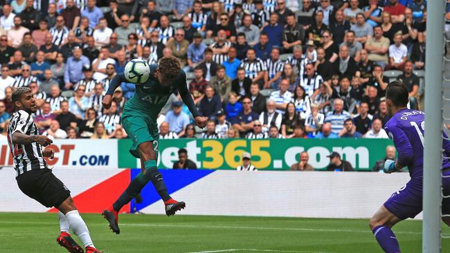 Tottenham Hotspur's English midfielder Dele Alli (C) heads the ball to score his team's second goal during the English Premier League football match between Newcastle United and Tottenham Hotspur at St James' Park in Newcastle-upon-Tyne, north east England on August 11, 2018. (Photo by Lindsey PARNABY / AFP) / RESTRICTED TO EDITORIAL USE. No use with unauthorized audio, video, data, fixture lists, club/league logos or 'live' services. Online in-match use limited to 120 images. An additional 40 images may be used in extra time. No video emulation. Social media in-match use limited to 120 images. An additional 40 images may be used in extra time. No use in betting publications, games or single club/league/player publications. /