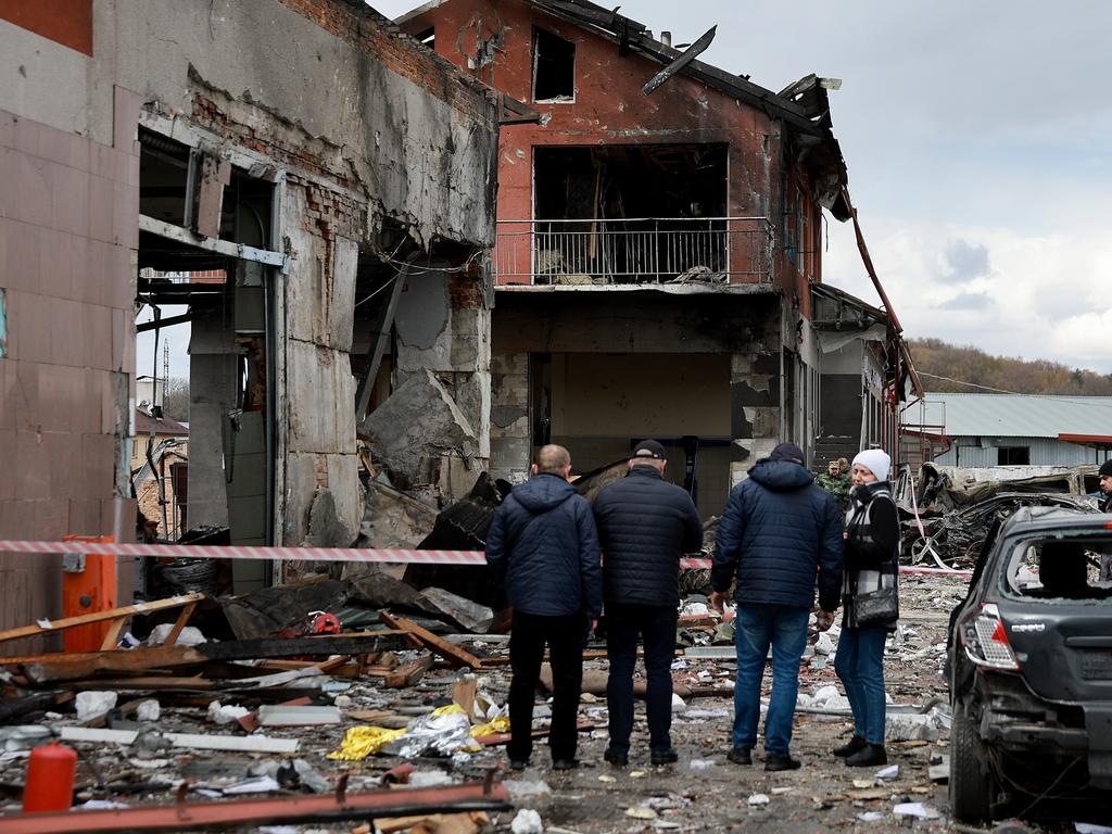 People look on at the destruction of a residential building that was hit by a Russian missile on April 18, 2022 in Lviv, Ukraine. Picture: Joe Raedle/Getty Images.