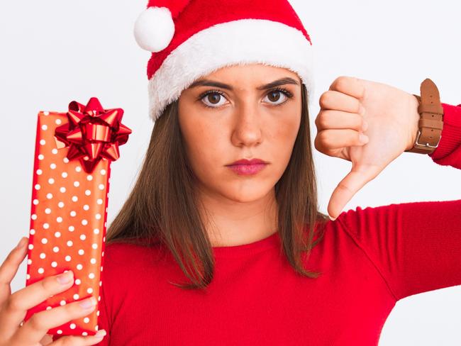 A young woman with a Christmas present she doesn't like.  Picture: iStock.