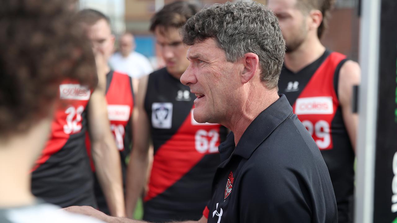 MELBOURNE, AUSTRALIA - MAY 02: Essendon VFL coach Leigh Tudor speaks to the players during the round three VFL match between Essendon Bombers and Carlton Blues at Windy Hill on May 2, 2021 in Melbourne, Australia. (Photo by Morgan Hancock/AFL Photos/via Getty Images)