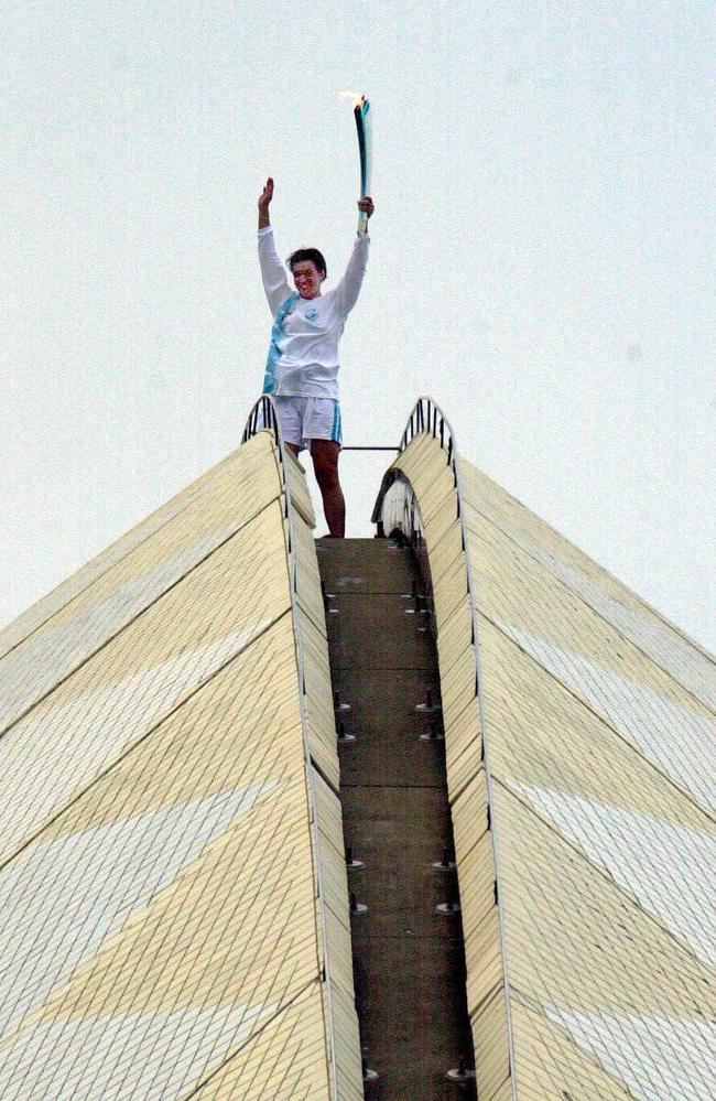 Samantha Riley holds the Olympic Torch at the top of the Opera House in September 2000. Picture: Mark Williams