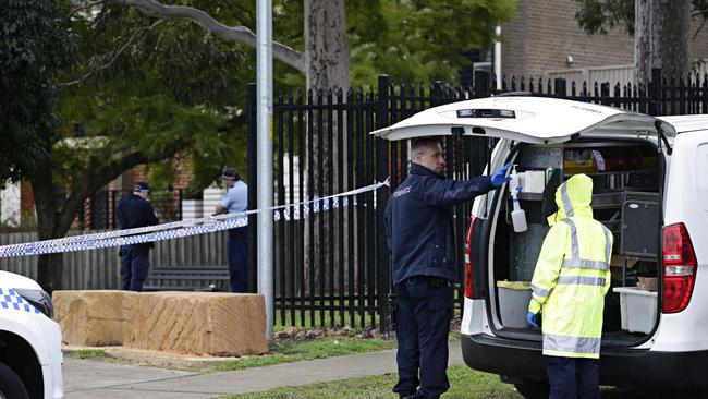 Police collect evidence after the stabbing. Picture: Adam Yip