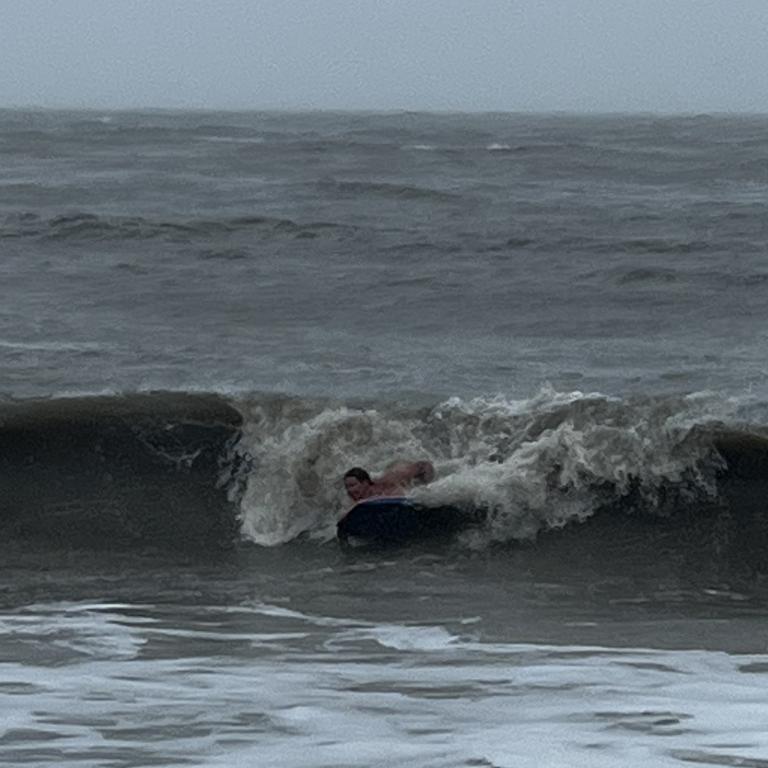 A local makes the most of the wild seas off Trinity Beach. Picture: Supplied