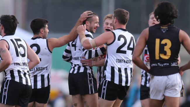 Adelaide Footy League, general action from on-field. Payneham Norwood Union vs Brighton at Payneham Oval. Payneham Norwood Union player, No. 4, Jed Spence is congratulated by teammates after kicking a goal.Picture: Dean Martin