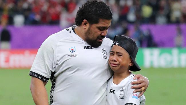 Campese Ma'afu of Fiji walks off the pitch with his son. Photo: Koki Nagahama/Getty Images