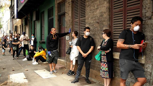 Anthony Mundine handed out water to people in the Darlinghurst Centrelink queue in March last year. Picture: Phil Hillyard