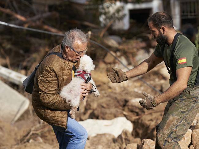 A man carries a dog in Letur, Albacete province, Spain. Picture: Getty Images