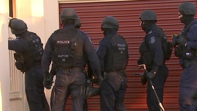 Officers from Strike Force Raptor on a raid. Picture: NSW Police