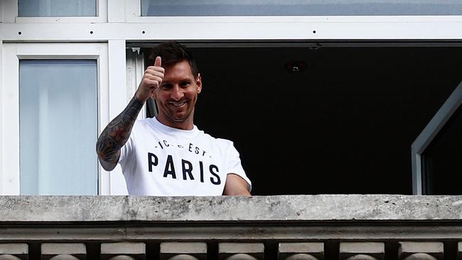 Argentinian football player Lionel Messi waves at fans.