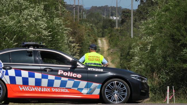 A Highway Patrol car blocks Virginia Rd Fire Trail at Hamlyn Terrace where the LandCruiser was driven to before it was set alight. Picture: Richard Noone