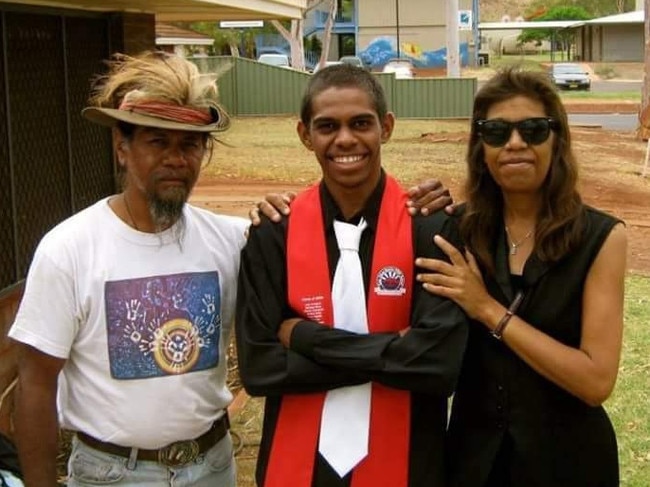 Shaka Cook at his Year 12 graduation at Tom Price Senior High School with his parents. He was the first person in his family to graduate from high school. Picture: Supplied