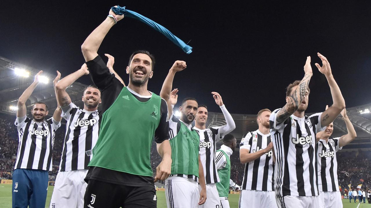 Buffon celebrates with teammates after Juventus clinched the title.