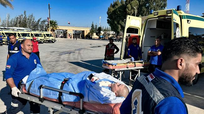 Egyptian paramedics transfer an injured Palestinian boy to an ambulance. Picture: AFP